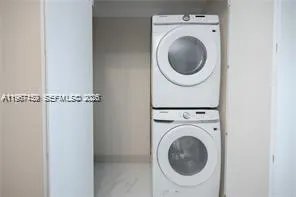 an empty room with a ceiling fan and a window