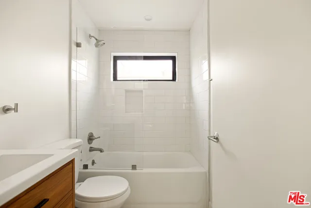 a bathroom with a toilet a sink and bathtub