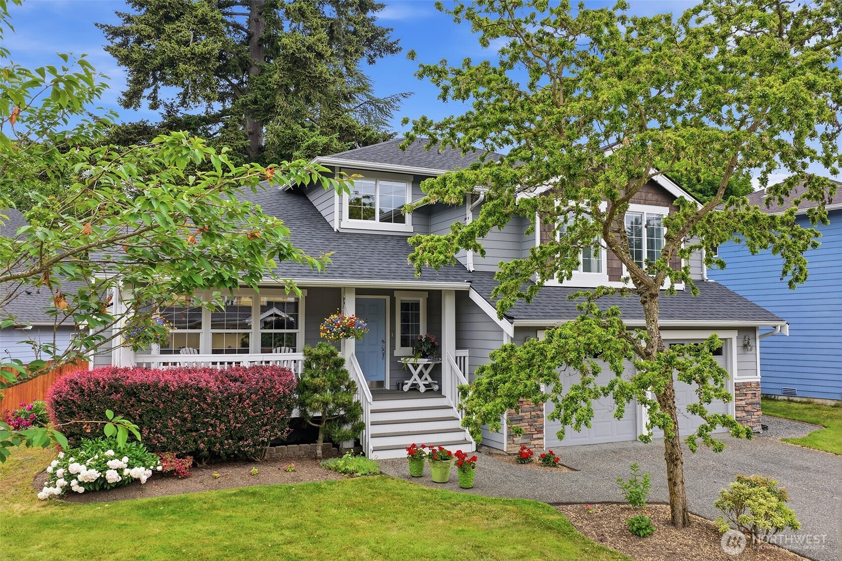17747 89th Court Northeast Bothell, WA 98011 - Photo 2 of 33 a front view of a house with a garden