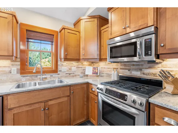 a kitchen with a sink stove and microwave
