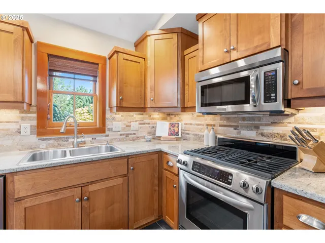 a kitchen with a sink stove and microwave