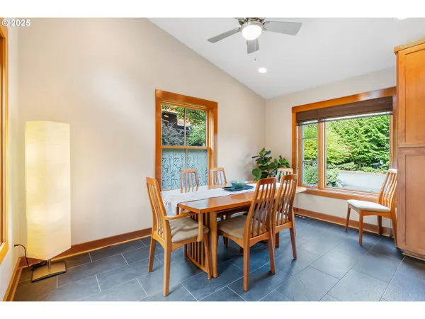 a dining room with furniture and a floor to ceiling window