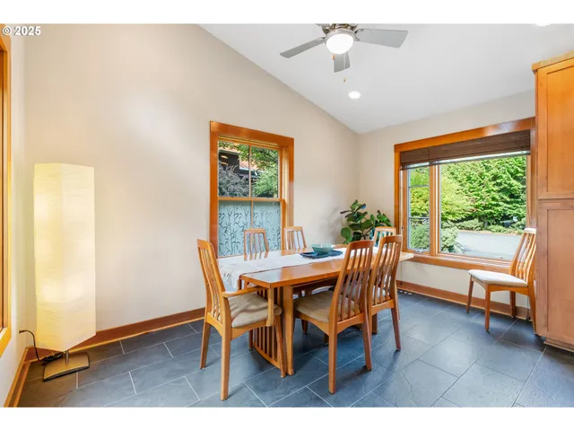 a dining room with furniture and a floor to ceiling window