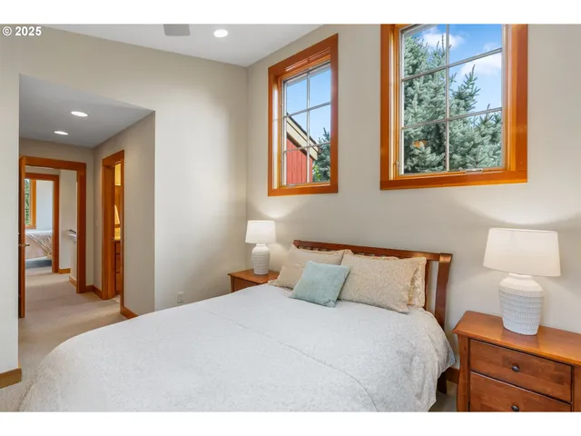 a bedroom with a bed and a lamp on dresser