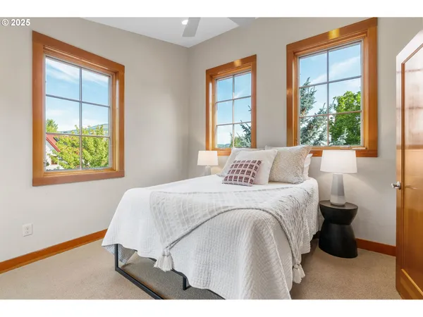 a bedroom with a bed and windows