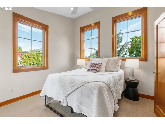 a bedroom with a bed and windows