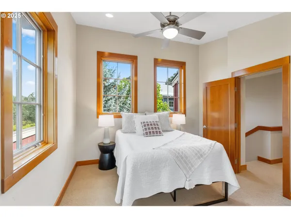 a bedroom with a large bed and a chandelier