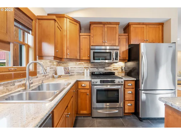 a kitchen with a refrigerator sink and oven