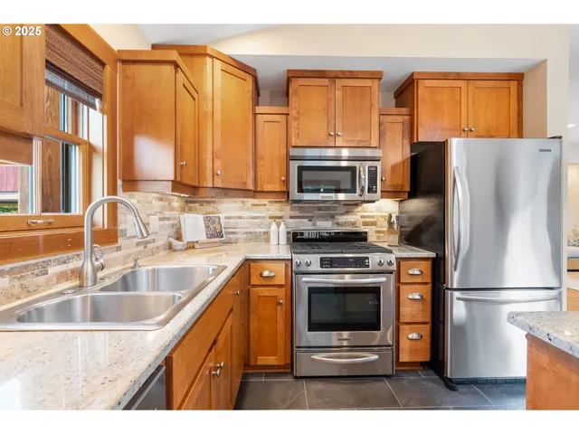 a kitchen with a refrigerator sink and oven