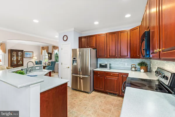 a kitchen with a stove a counter space dining table and chairs