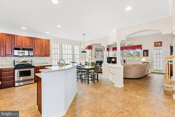 a kitchen with a table chairs refrigerator and cabinets
