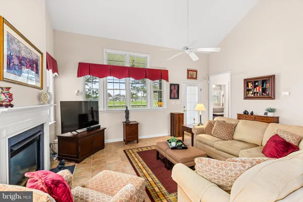 a living room with furniture fireplace and flat screen tv