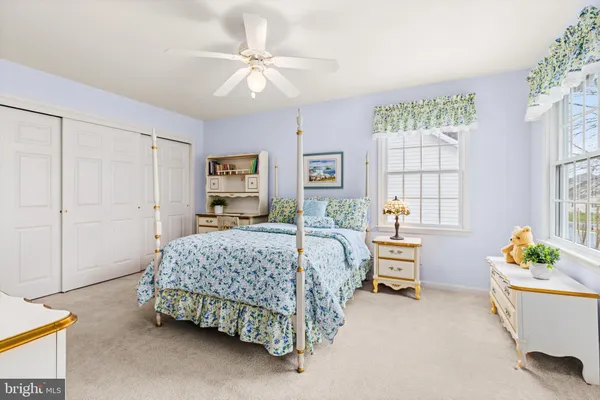 a sign that is sitting in front of a house with a big yard