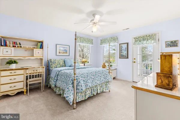 an aerial view of a swimming pool with lawn chairs and large trees