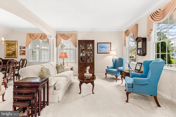 a living room with furniture and kitchen view