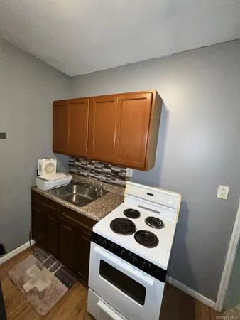a kitchen with a sink a stove and cabinets