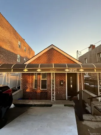 a front view of a house with parking space