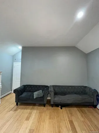 a living room with a couch and a wooden floor