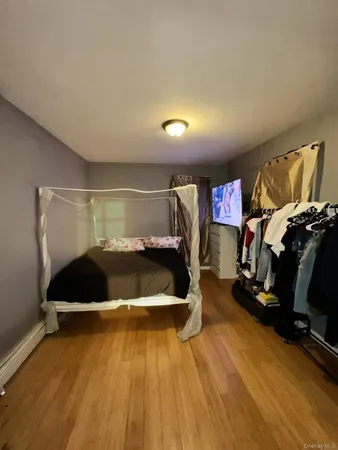 a room with wooden floor and gym equipment