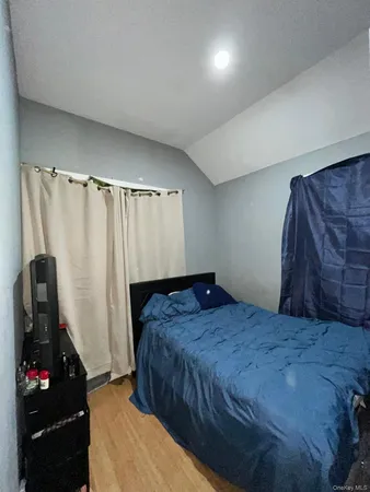 a bedroom with a bed and a mirror