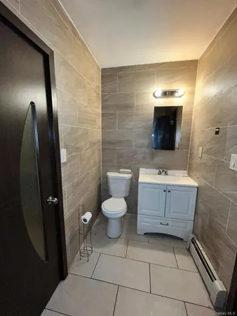 a bathroom with a sink a toilet and mirror
