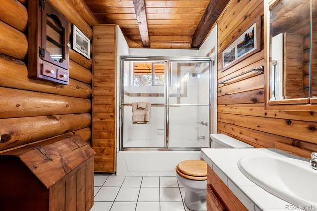 a bedroom with furniture a flat screen tv and a window