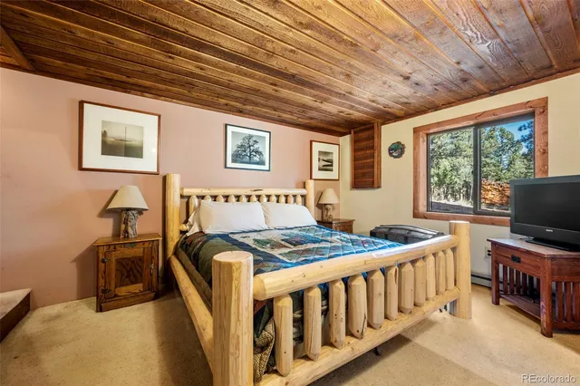 a bedroom with furniture and a large window