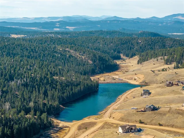 a view of a swimming pool with a yard