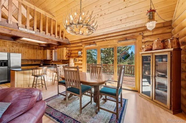 a dining room with furniture and wooden floor