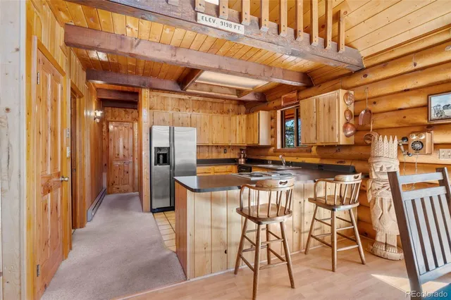 a view of a kitchen with a table and chairs