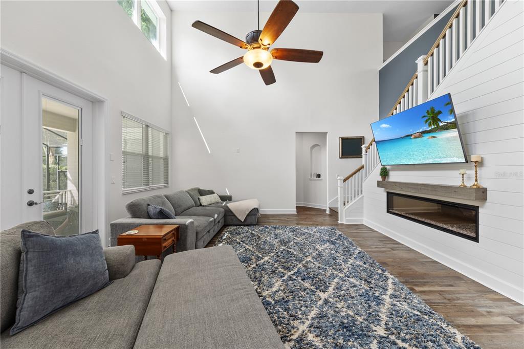 16948 Deer Island Road Tavares, FL 32778 - Photo 5 of 67 a living room with furniture and a rug