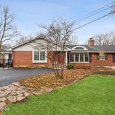 a front view of a house with a garden and yard