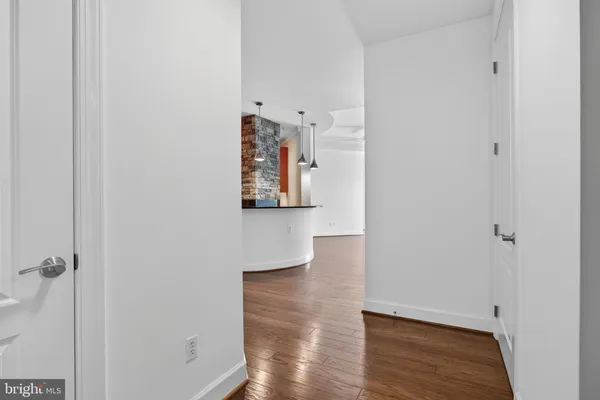 a view of hallway with wooden floor
