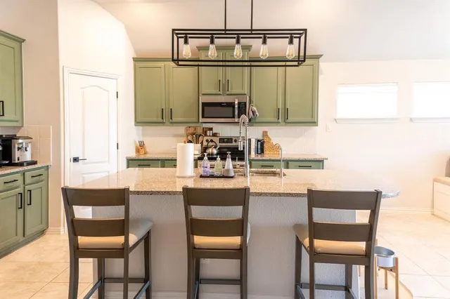 a kitchen with a table and chairs in it