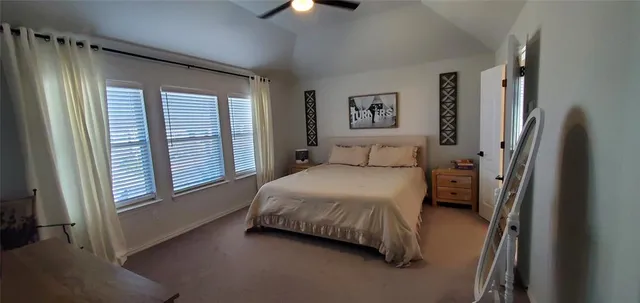 a bedroom with a bed next to a window