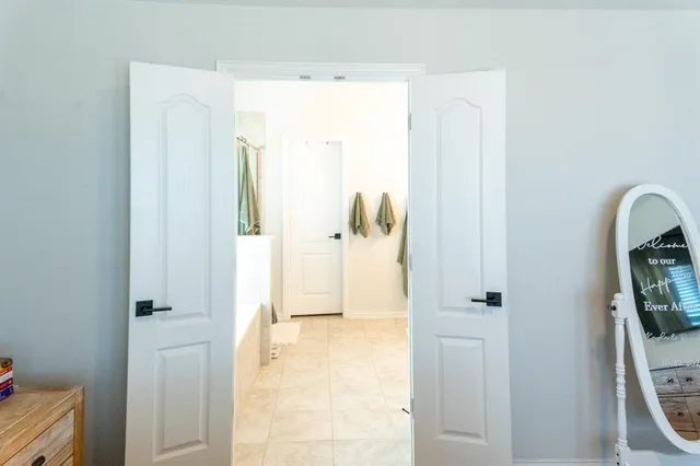 a view of a bathroom from a hallway