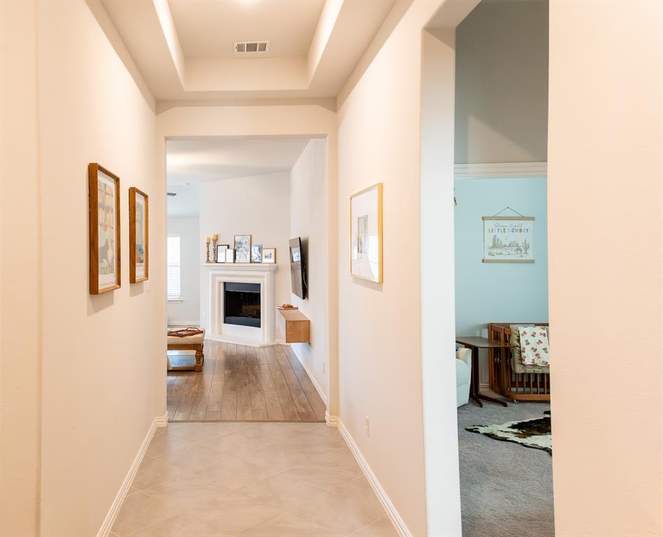 416 Windy Knoll Road Fort Worth, TX 76028 - Photo 2 of 34 a view of a hallway with furniture and a kitchen view
