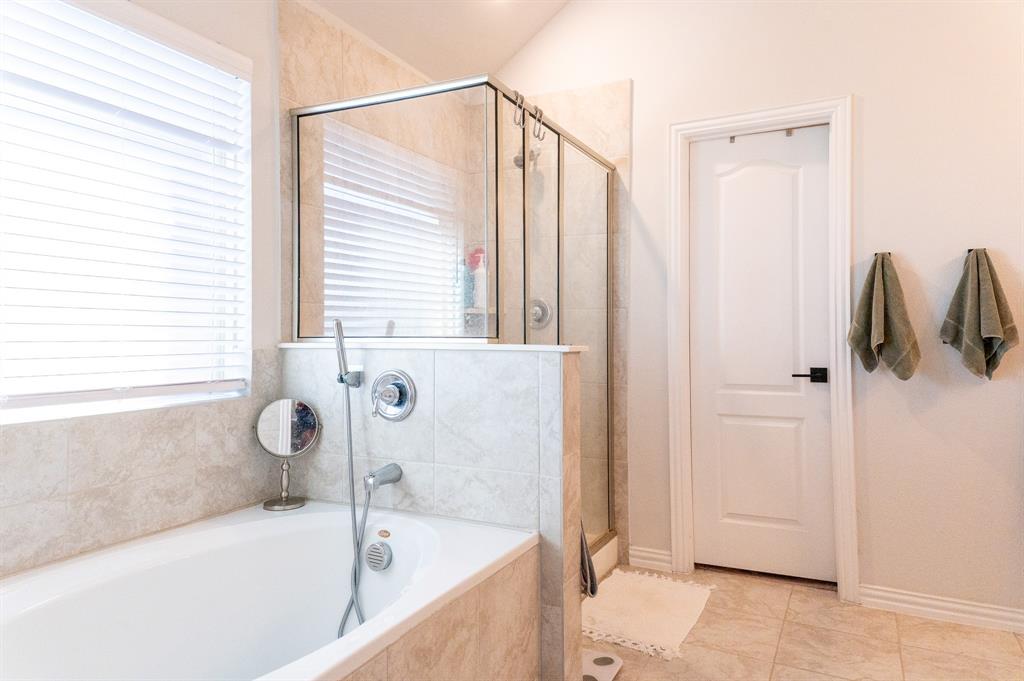 416 Windy Knoll Road Fort Worth, TX 76028 - Photo 21 of 34 a bathroom with a bathtub and a shower
