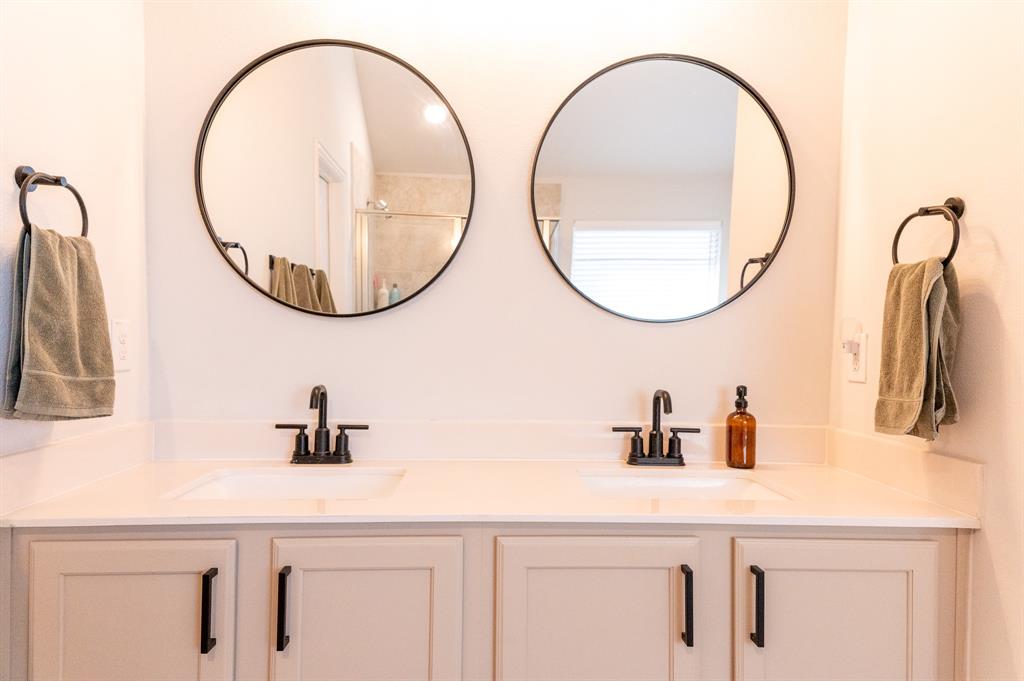 416 Windy Knoll Road Fort Worth, TX 76028 - Photo 23 of 34 a bathroom with a sink and a mirror