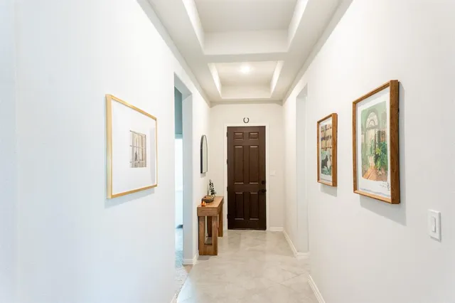 a view of a hallway with windows and bathroom