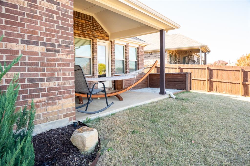 416 Windy Knoll Road Fort Worth, TX 76028 - Photo 30 of 34 a patio with table and chairs