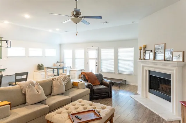 a living room with furniture ceiling fan and a fireplace
