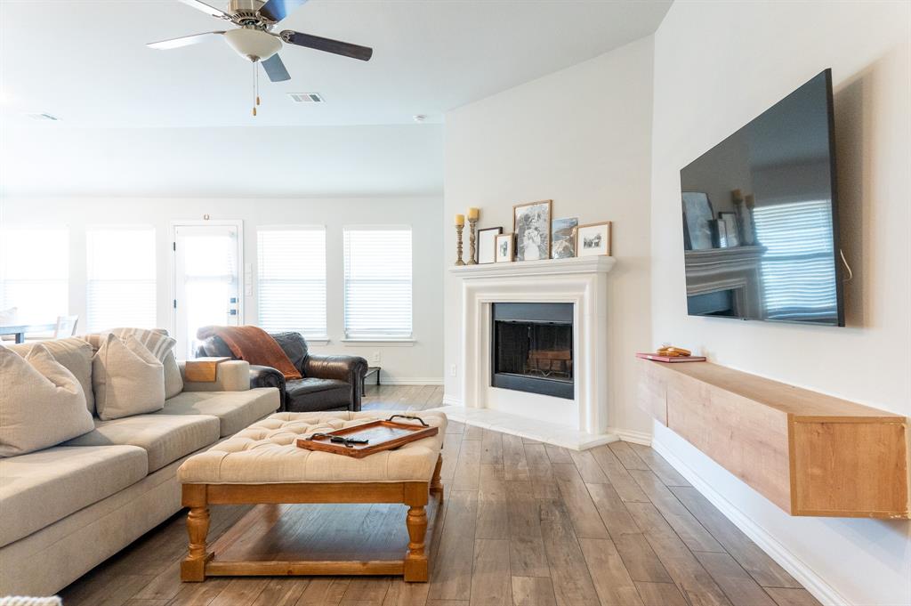 416 Windy Knoll Road Fort Worth, TX 76028 - Photo 4 of 34 a living room with furniture and a fireplace