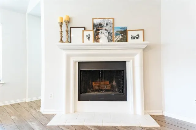 a living room with a fireplace and wooden floor