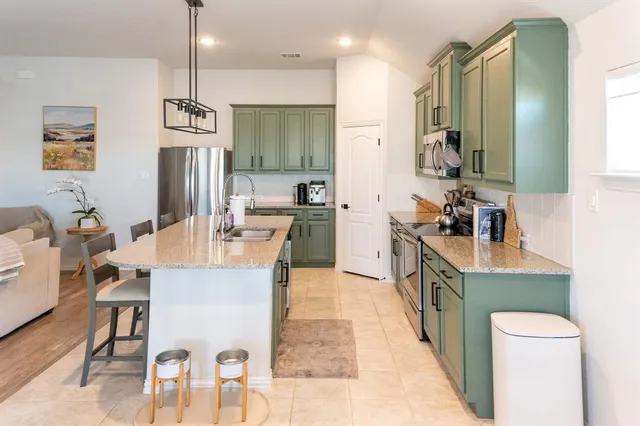 a large kitchen with a table and chairs