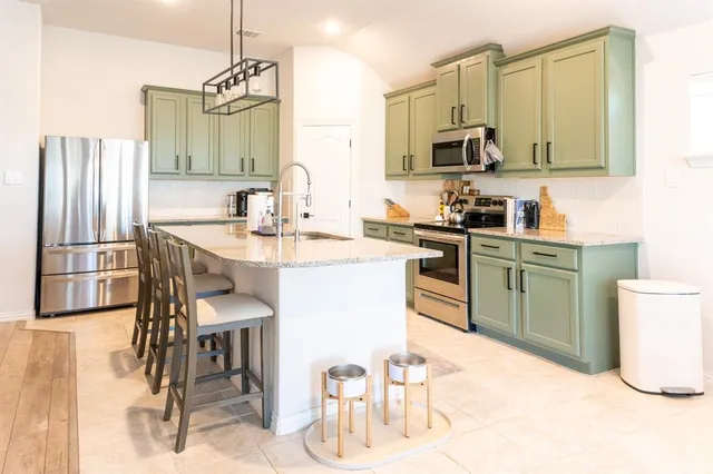 a kitchen with a sink cabinets and stainless steel appliances