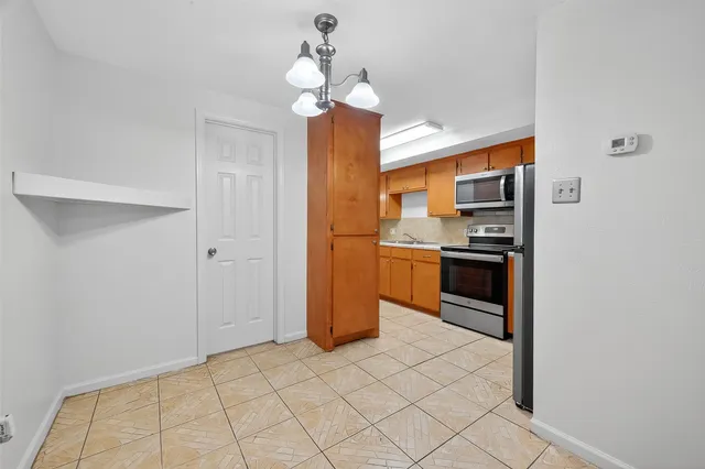 a kitchen with stainless steel appliances a refrigerator and a stove