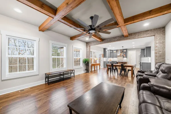 a kitchen with stainless steel appliances granite countertop a sink stove and wooden floor