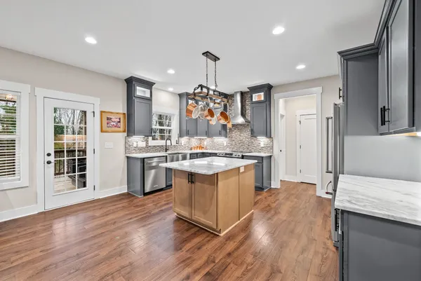 a kitchen with lots of counter top space and painting on the wall