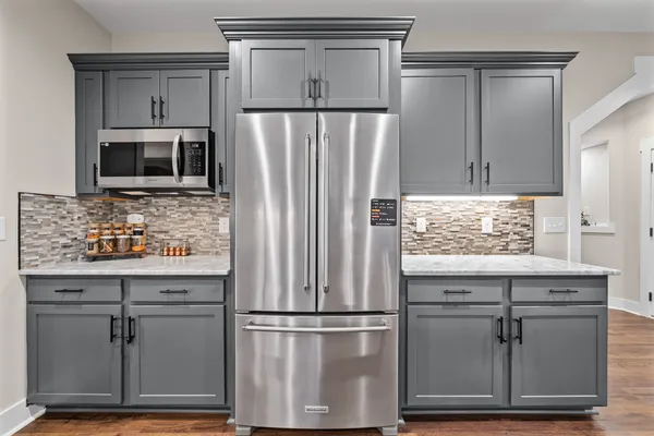 a kitchen with stainless steel appliances granite countertop a sink and a stove